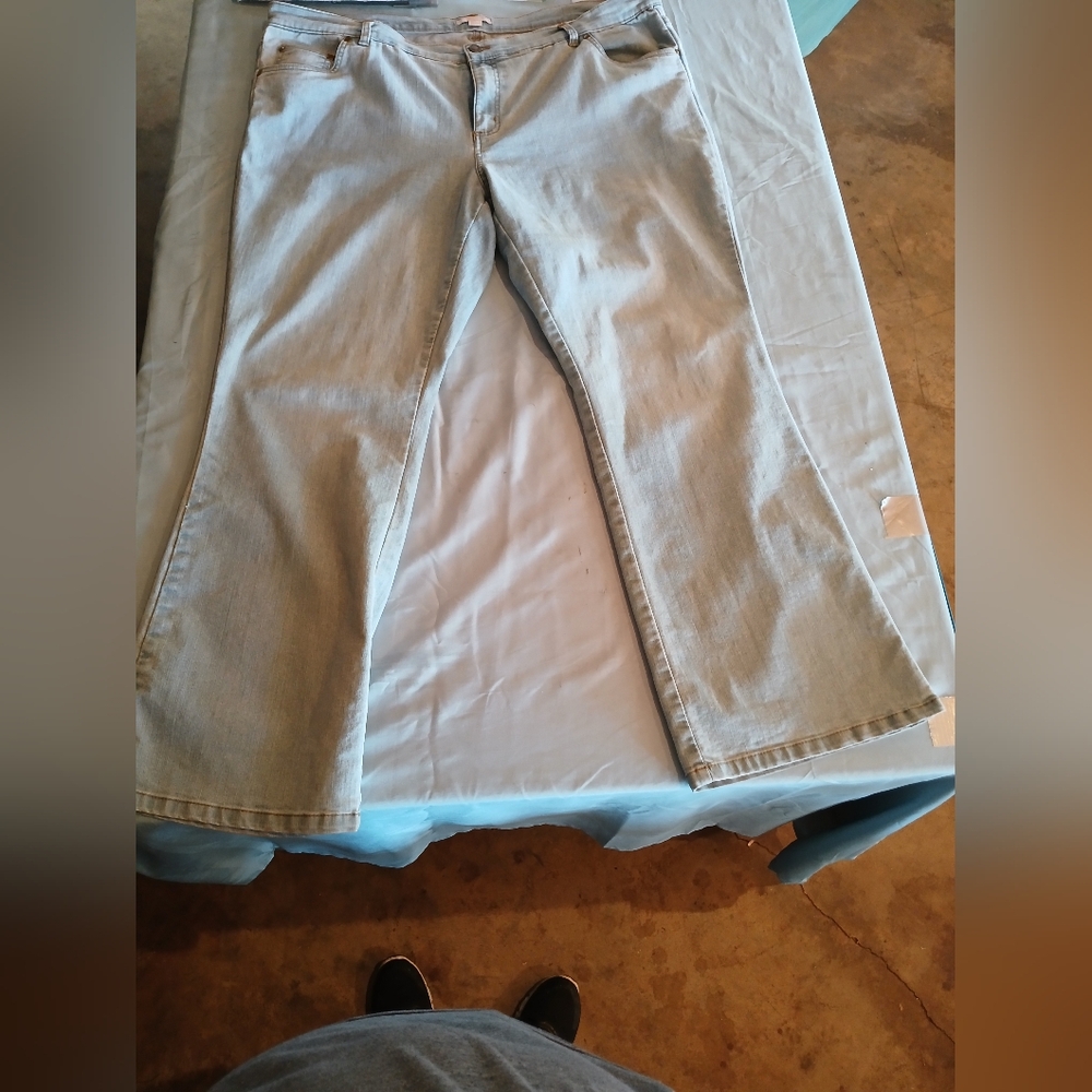 Woman within light blue jeans size 20
